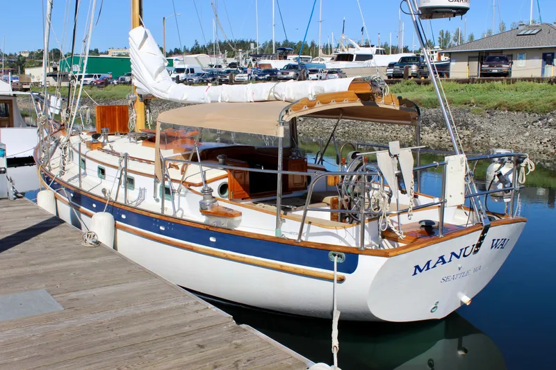 Slide: The Image of Cape George 38 sailboat, 1988 model, docked at marina with clear blue sky. - 12