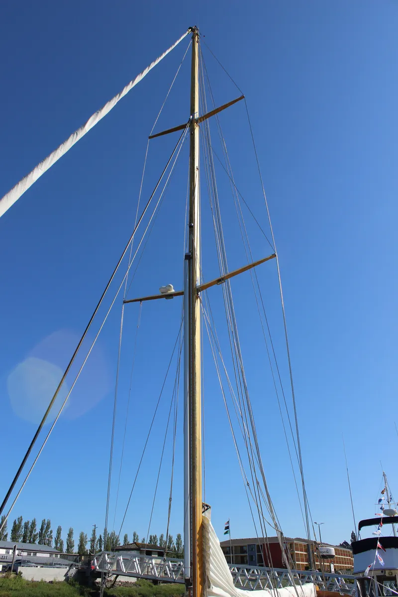 Slide: The Image of Tall mast of a 1988 Cape George 38 sailboat against a clear blue sky. - 13