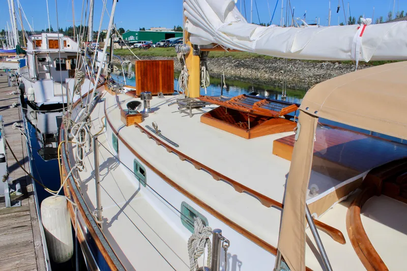 Slide: The Image of 1988 Cape George 38 sailboat docked, showcasing deck and rigging details. - 15