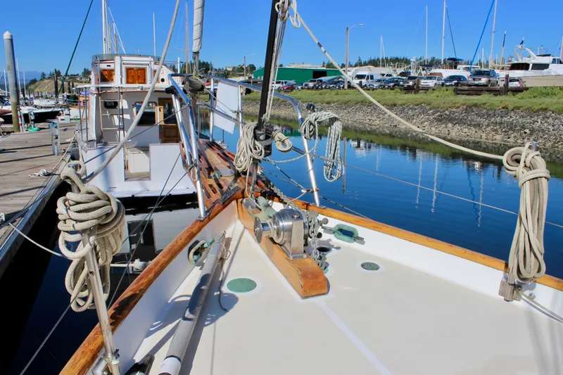 Slide: The Image of Cape George 38 sailboat from 1988 docked in a marina, showcasing deck and rigging. - 19