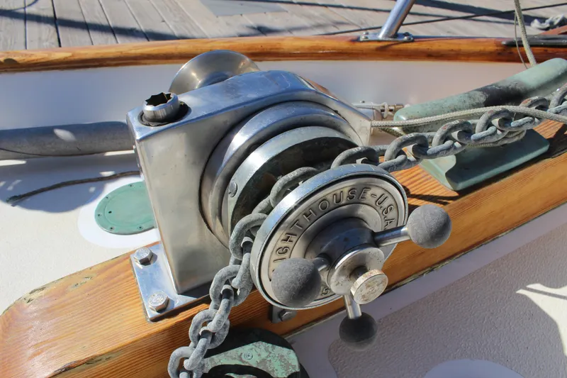 Slide: The Image of Winch on 1988 Cape George 38 sailboat deck with chain and wooden trim. - 21