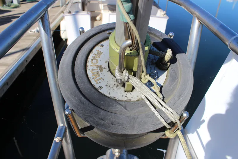 Slide: The Image of Furling system on a 1988 Cape George 38 sailboat, docked at a marina. - 23