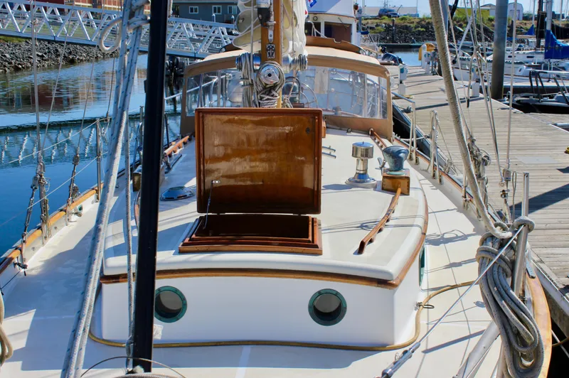 Slide: The Image of 1988 Cape George 38 sailboat docked at marina, showcasing deck and cabin details. - 24