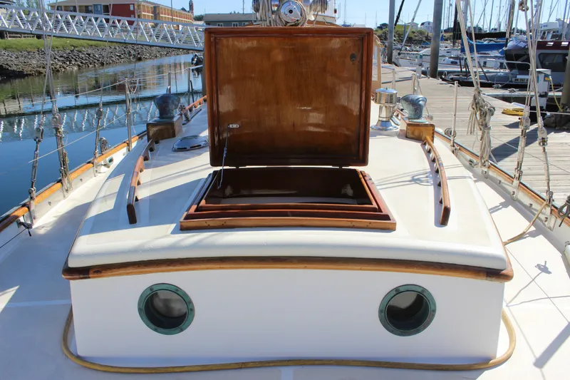 Slide: The Image of 1988 Cape George 38 sailboat deck with open hatch and portholes at marina. - 25