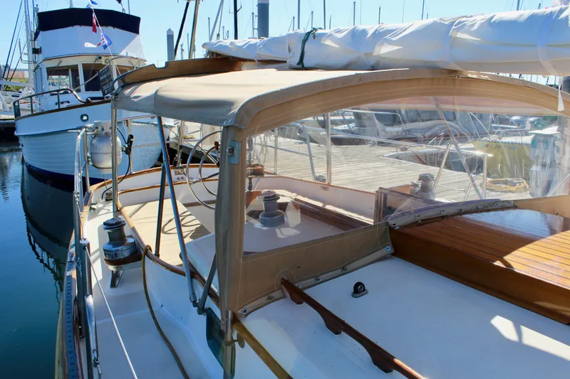 Slide: The Image of 1988 Cape George 38 sailboat with covered cockpit, docked at marina. - 30