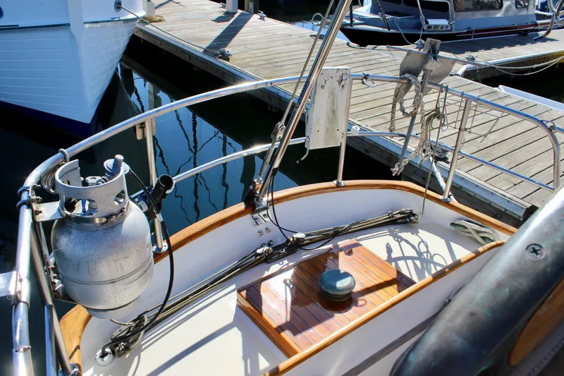 Slide: The Image of 1988 Cape George 38 sailboat deck with propane tank and marina view. - 34