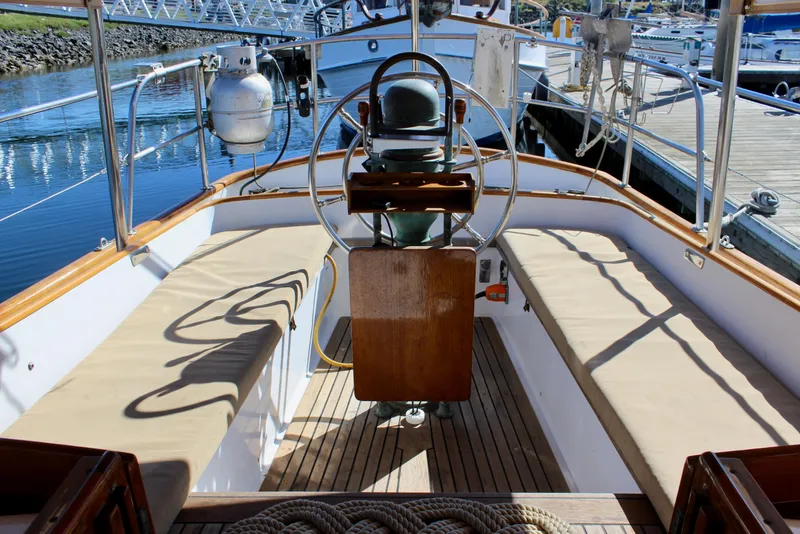 Slide: The Image of Cockpit of 1988 Cape George 38 sailboat with wooden accents and steering wheel. - 35