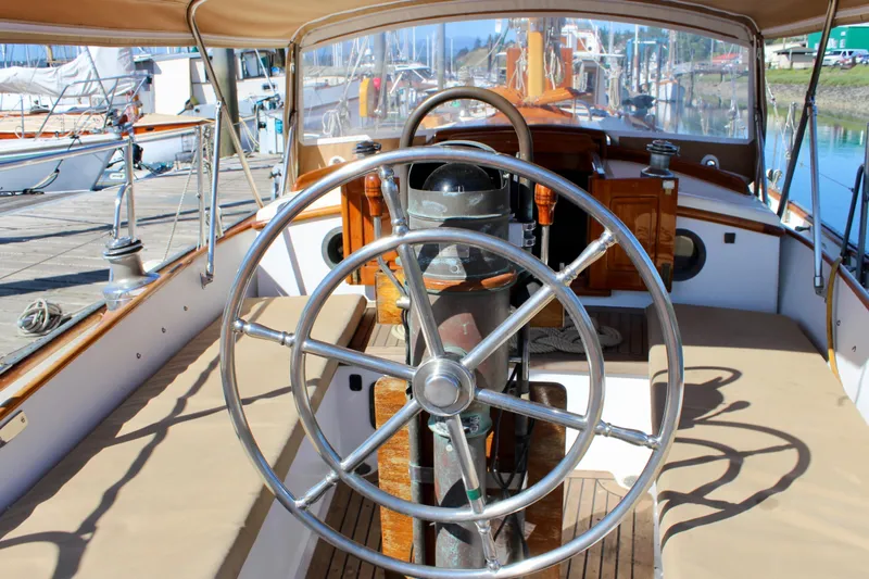 Slide: The Image of Steering wheel of a 1988 Cape George 38 sailboat, docked at a marina. - 37