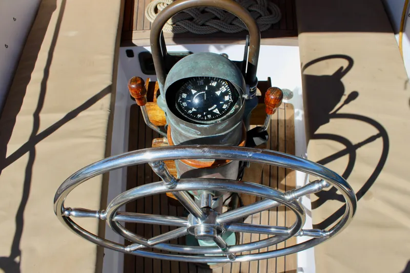 Slide: The Image of Steering wheel and compass of a 1988 Cape George 38 sailboat. - 38