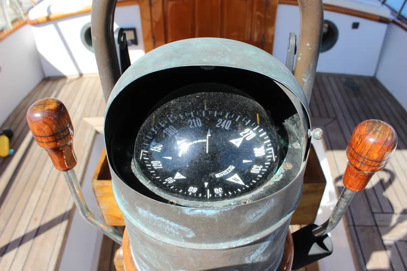 Slide: The Image of Compass on 1988 Cape George 38 sailboat, wooden handles, and deck visible. - 39