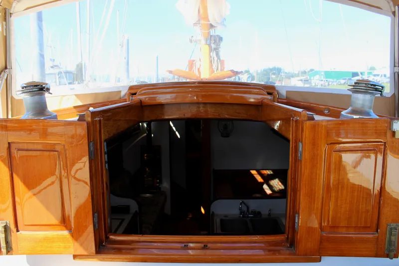 Slide: The Image of 1988 Cape George 38 sailboat with open wooden cabin doors, showcasing interior. - 44