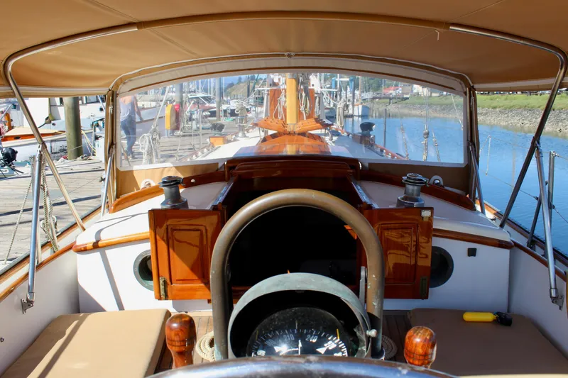 Slide: The Image of Cockpit view of a 1988 Cape George 38 sailboat docked at a marina. - 46