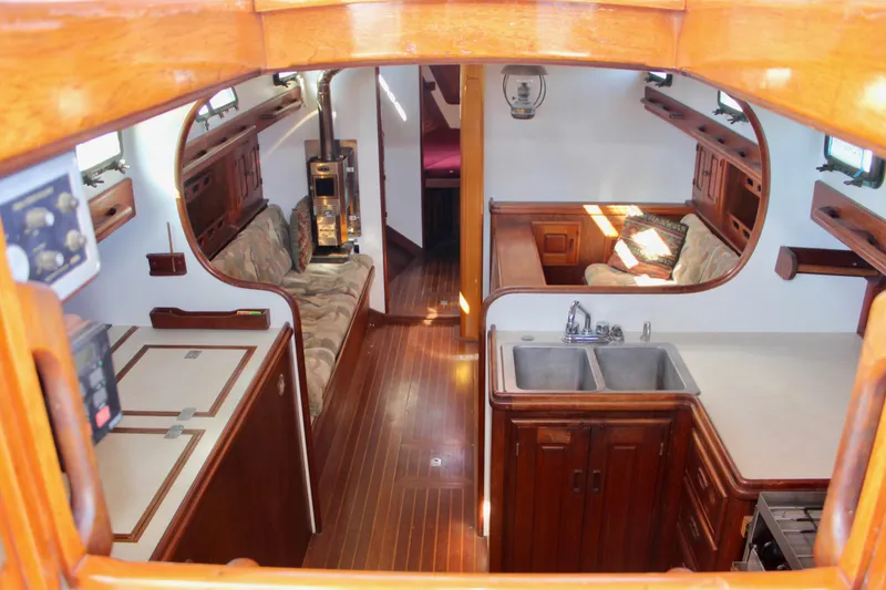 Slide: The Image of Interior of 1988 Cape George 38 sailboat with wood finish and cozy seating area. - 47