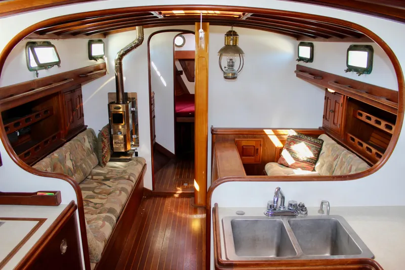Slide: The Image of Interior of a 1988 Cape George 38 sailboat with wood finishes and cozy seating. - 48
