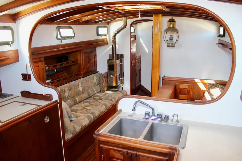 Slide: The Image of Interior of 1988 Cape George 38 sailboat with wooden finishes and cozy seating area. - 49