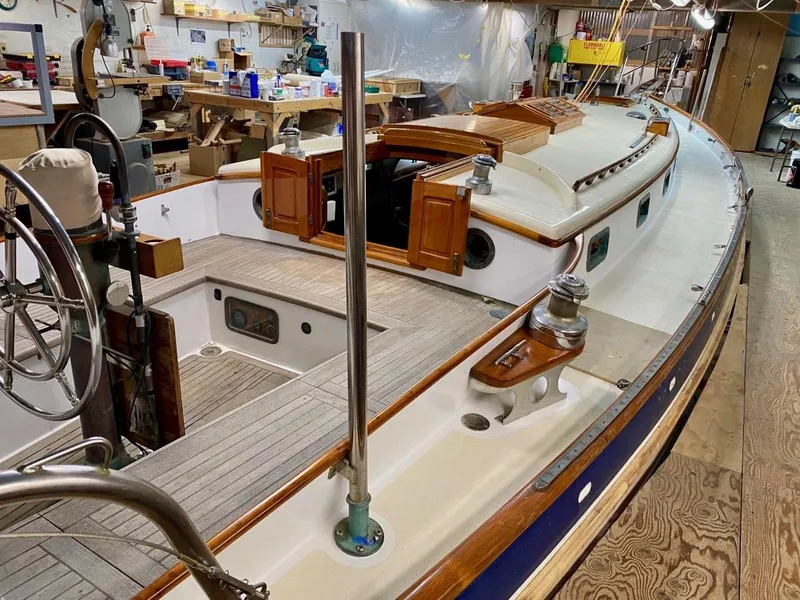 Slide: The Image of 1988 Cape George 38 sailboat in workshop, showcasing deck and cabin details. - 6