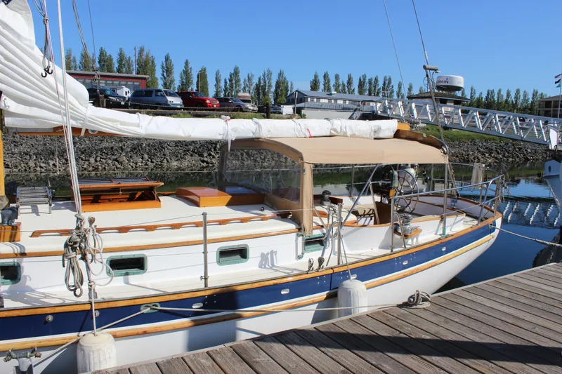 Slide: The Image of Sailboat docked at marina, Cape George 38, 1988 model, with tan canopy and white hull. - 9