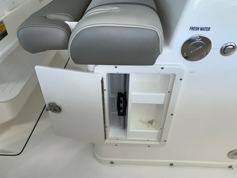 Slide: The Image of 2024 Key West 263 FS boat interior storage compartment with fresh water access. - 11