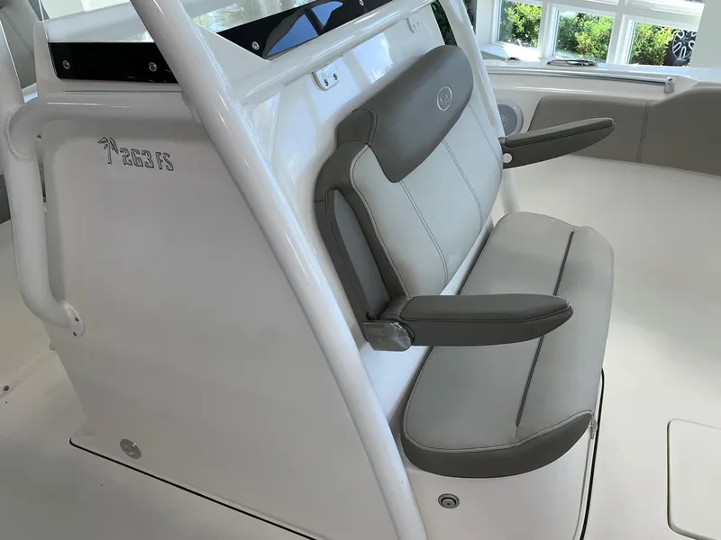 Slide: The Image of 2024 Key West 263 FS boat seating area with cushioned seats and armrests. - 18