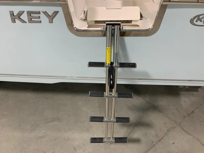 Slide: The Image of 2024 Key West 263 FS boat with a retractable ladder. - 21