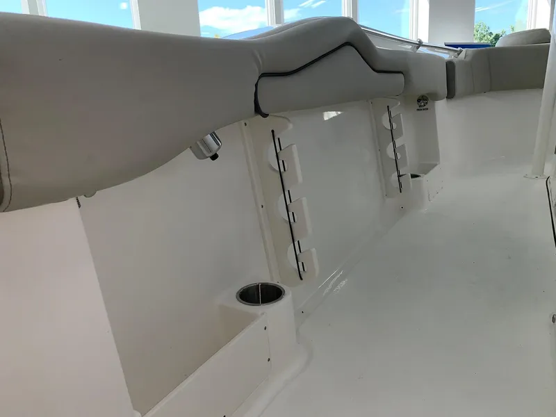 Slide: The Image of 2024 Key West 263 FS boat interior with cushioned seating and cup holder. - 4