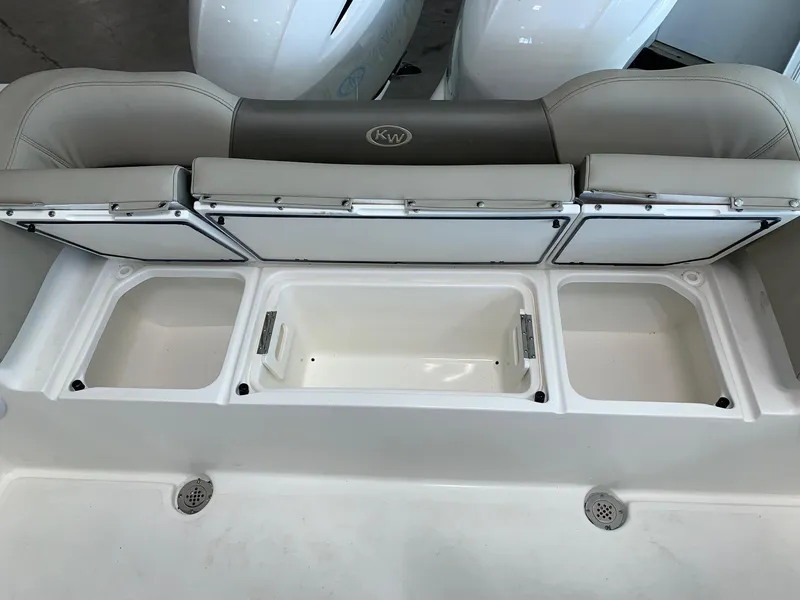 Slide: The Image of 2024 Key West 263 FS boat with open storage compartments. - 8