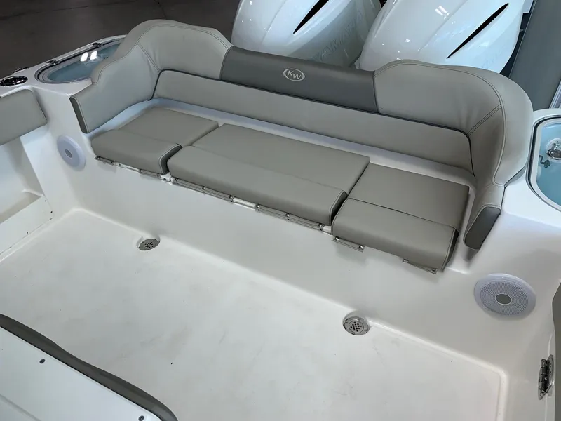 Slide: The Image of 2024 Key West 263 FS boat with cushioned seating and storage compartments. - 9