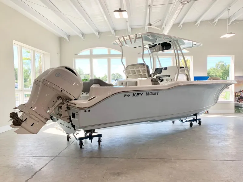 The Image of 2026 Key West 263 FS boat displayed indoors, showcasing sleek design and powerful engine. - 0