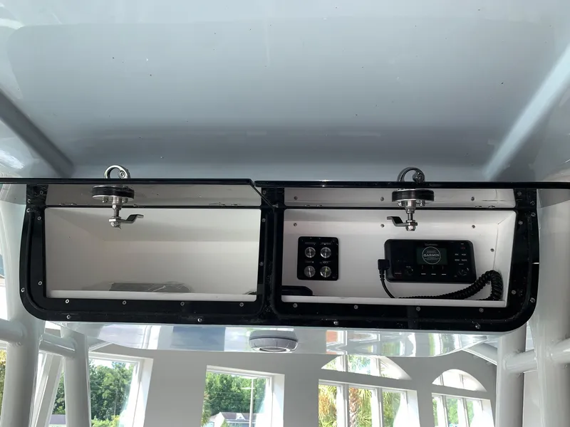 Slide: The Image of 2024 Key West 263 FS boat console storage with electronic controls. - 13