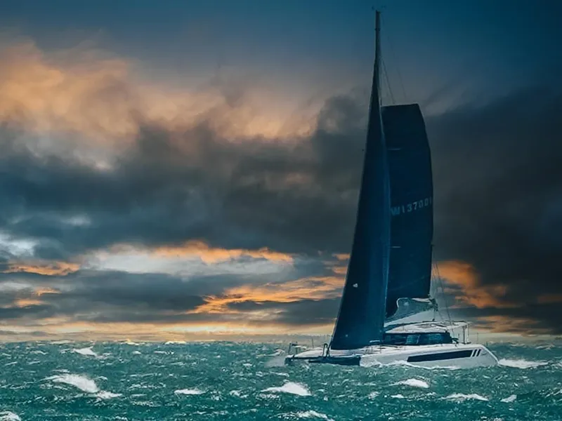 Slide: The Image of 2025 Seawind 1370 sailing in rough seas at sunset. - 6