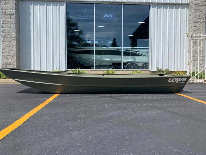 Slide: The Image of 2024 Lowe L1436 boat displayed outside a showroom on a sunny day. - 1