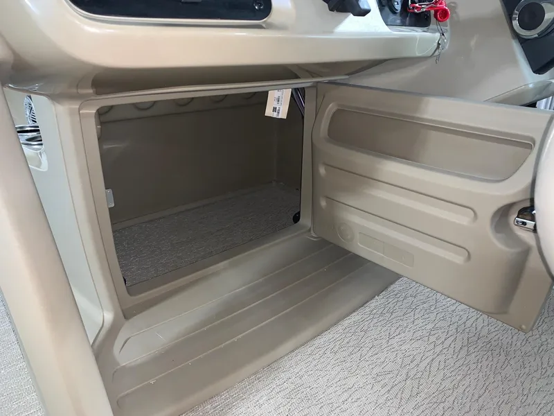 Slide: The Image of 2024 Starcraft LX22 F boat storage compartment with open door. - 12