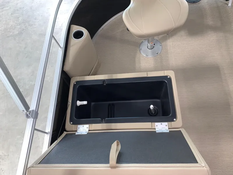 Slide: The Image of 2024 Starcraft LX22 F boat interior with open storage compartment and beige seating. - 12
