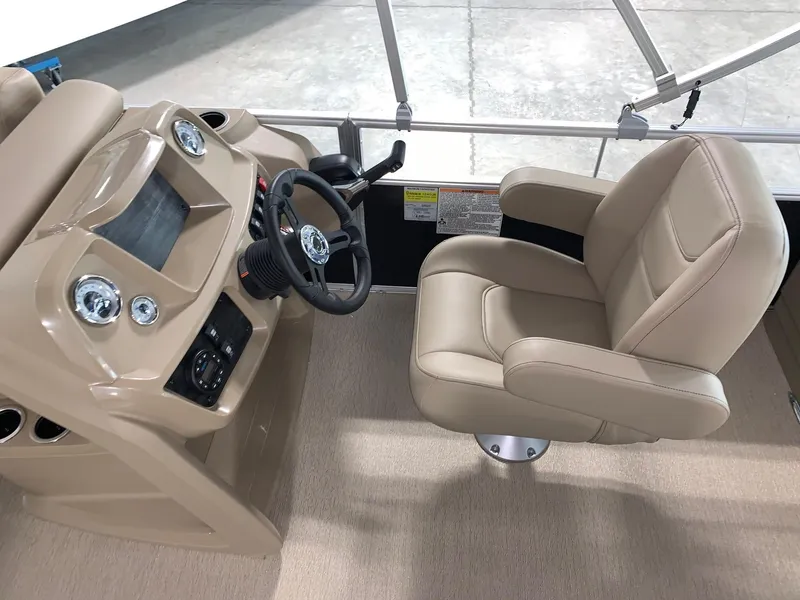 Slide: The Image of 2024 Starcraft LX22 F boat helm with beige captain's chair and control panel. - 13