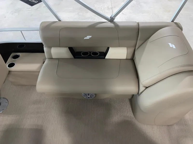 Slide: The Image of 2024 Starcraft LX22 F boat interior with beige seating and cup holders. - 15