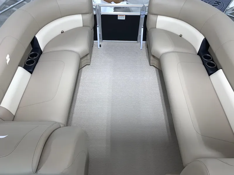 Slide: The Image of 2024 Starcraft LX22 F boat interior with beige seating and cup holders. - 6