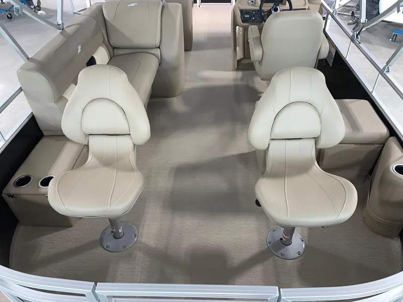 Slide: The Image of 2024 Starcraft LX22 F pontoon boat interior with beige seating. - 7