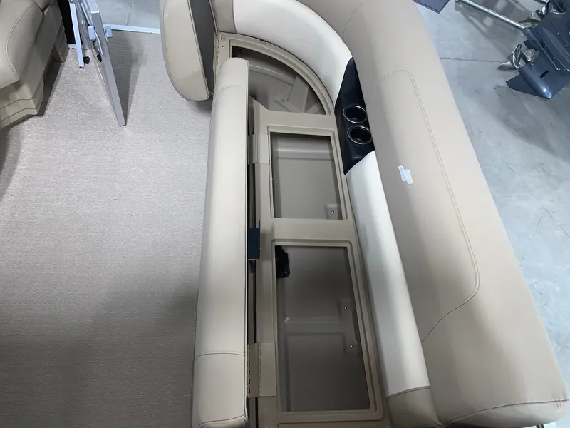 Slide: The Image of 2024 Starcraft LX22 F boat with beige seating and storage compartments. - 8