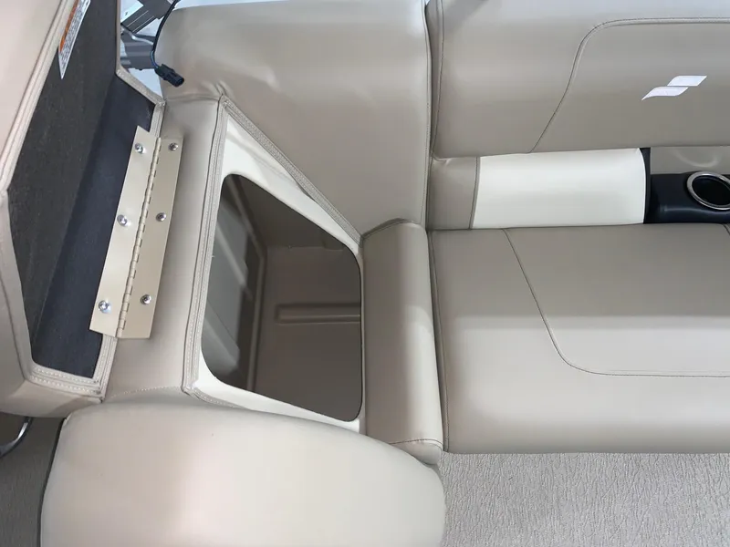 Slide: The Image of 2024 Starcraft LX22 R boat interior storage compartment with beige seating. - 10