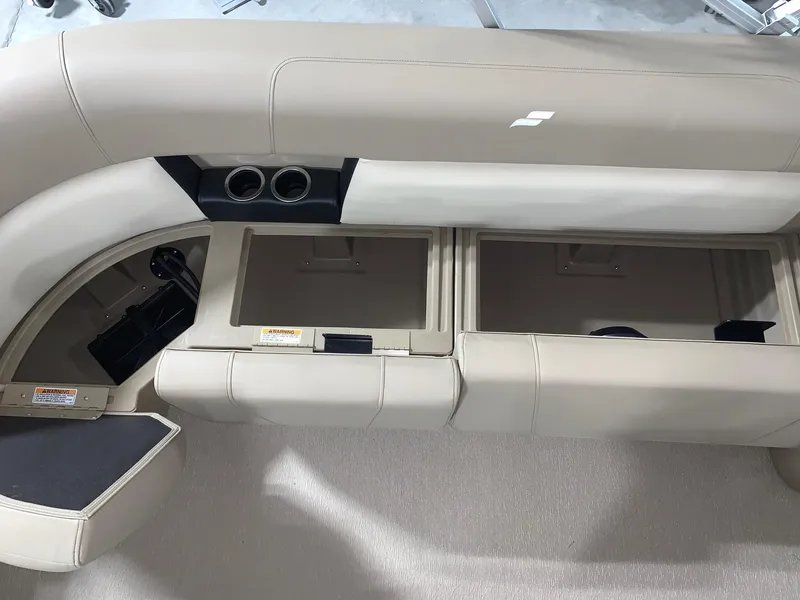 Slide: The Image of 2024 Starcraft LX22 R boat interior seating and storage compartments. - 11