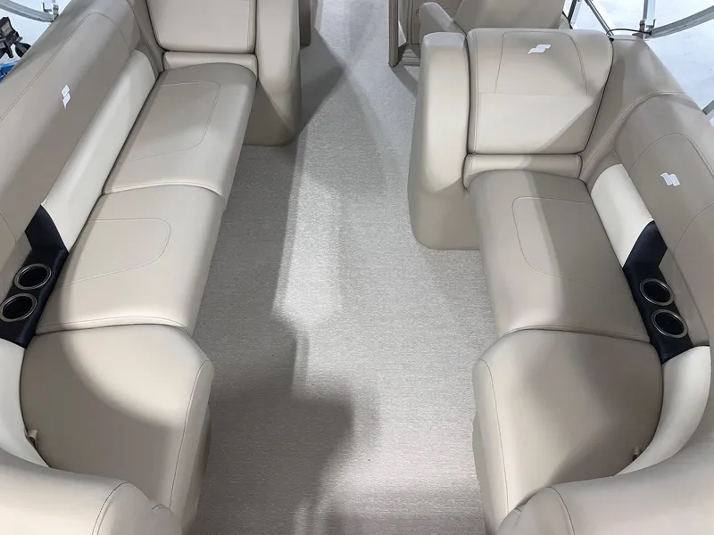 Slide: The Image of 2024 Starcraft LX22 R boat interior with beige seating and cup holders. - 12