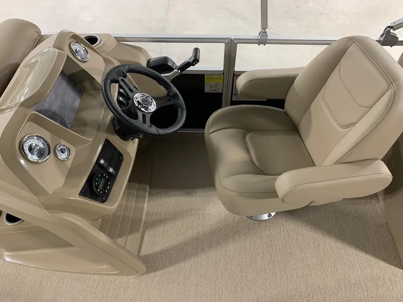 Slide: The Image of 2024 Starcraft LX22 R boat interior with steering wheel and captain's chair. - 6