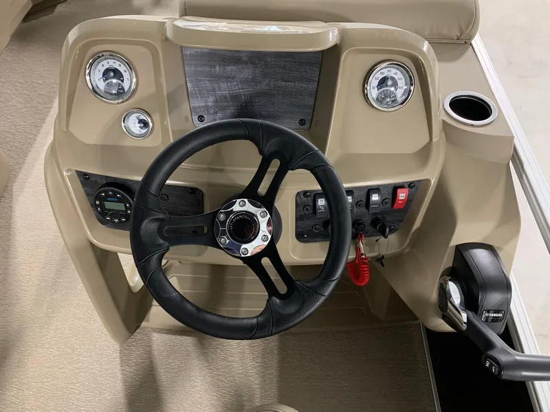 Slide: The Image of 2024 Starcraft LX22 R boat dashboard with steering wheel and control panel. - 7