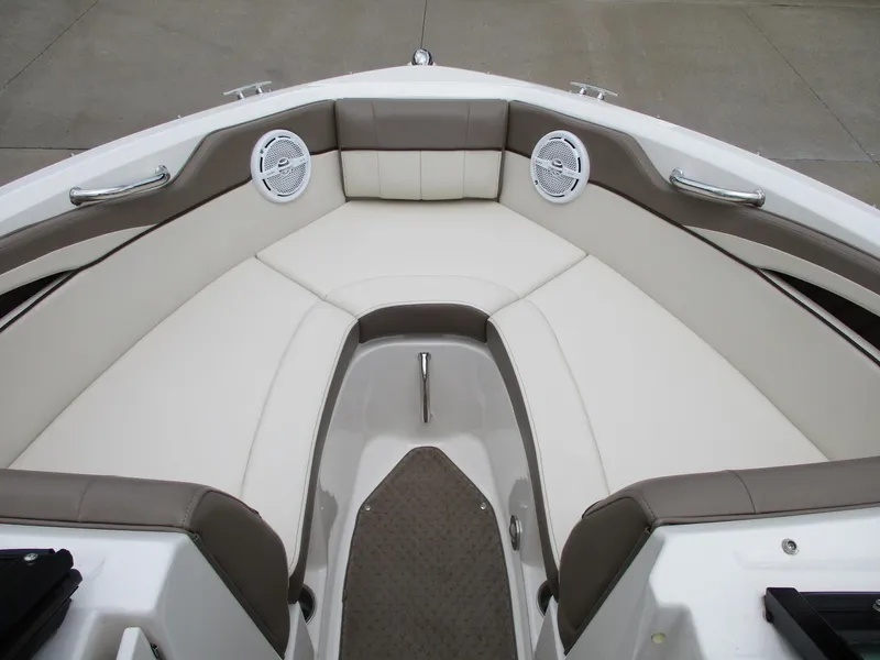 Slide: The Image of The image shows the bow area of a 2013 Sea Ray 210 SLX boat with cushioned seating. - 13