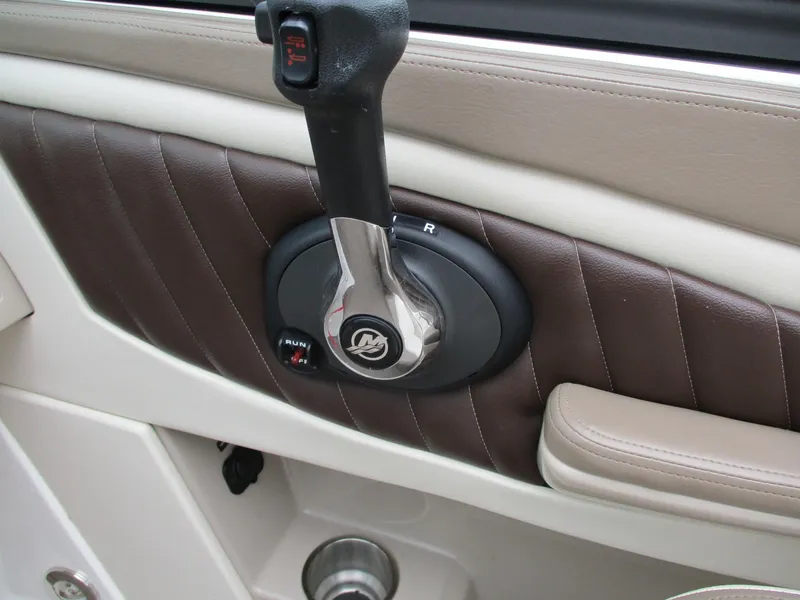 Slide: The Image of Close-up of a throttle lever in a 2013 Sea Ray 210 SLX boat. - 19