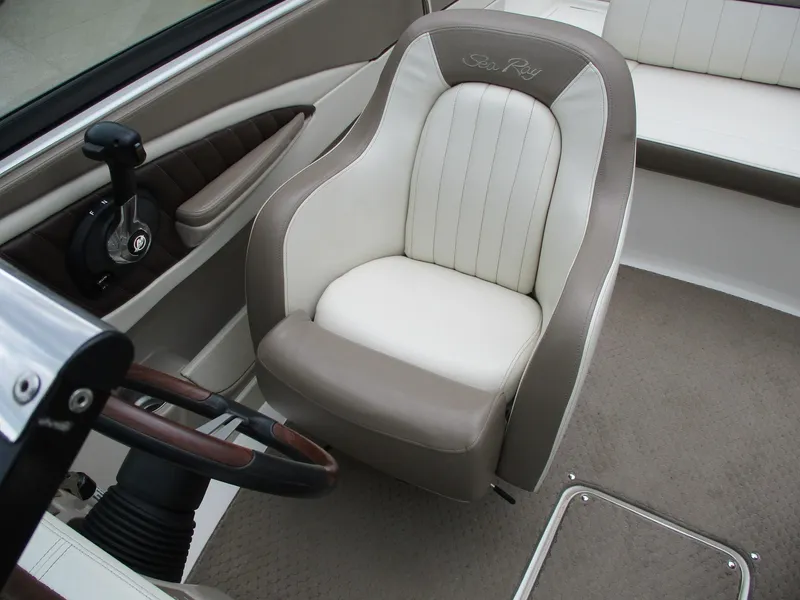 Slide: The Image of Interior of a 2013 Sea Ray 210 SLX with beige and white seating. - 16