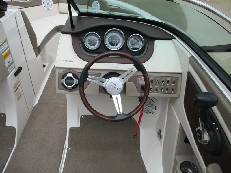 Slide: The Image of The image shows the cockpit of a 2013 Sea Ray 210 SLX with a sleek dashboard. - 17