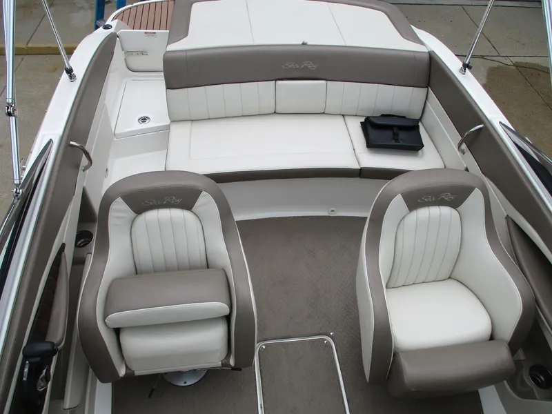 Slide: The Image of Interior of a 2013 Sea Ray 210 SLX with beige and white seating. - 14