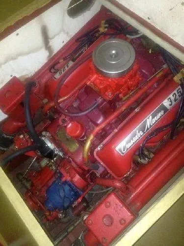 Slide: The Image of 1960 Century Coronado Crusader Marine 325 engine, red and silver, in a boat compartment. - 5