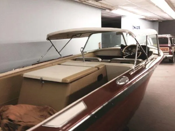 Slide: The Image of 1960 Century Coronado boat with canopy in indoor storage. - 7